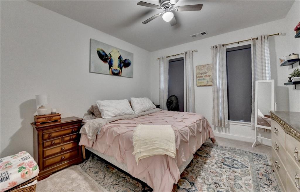 2129 Charmond Drive Monroe, GA 30656 - Photo 22 of 37 a bedroom with a bed and a chandelier