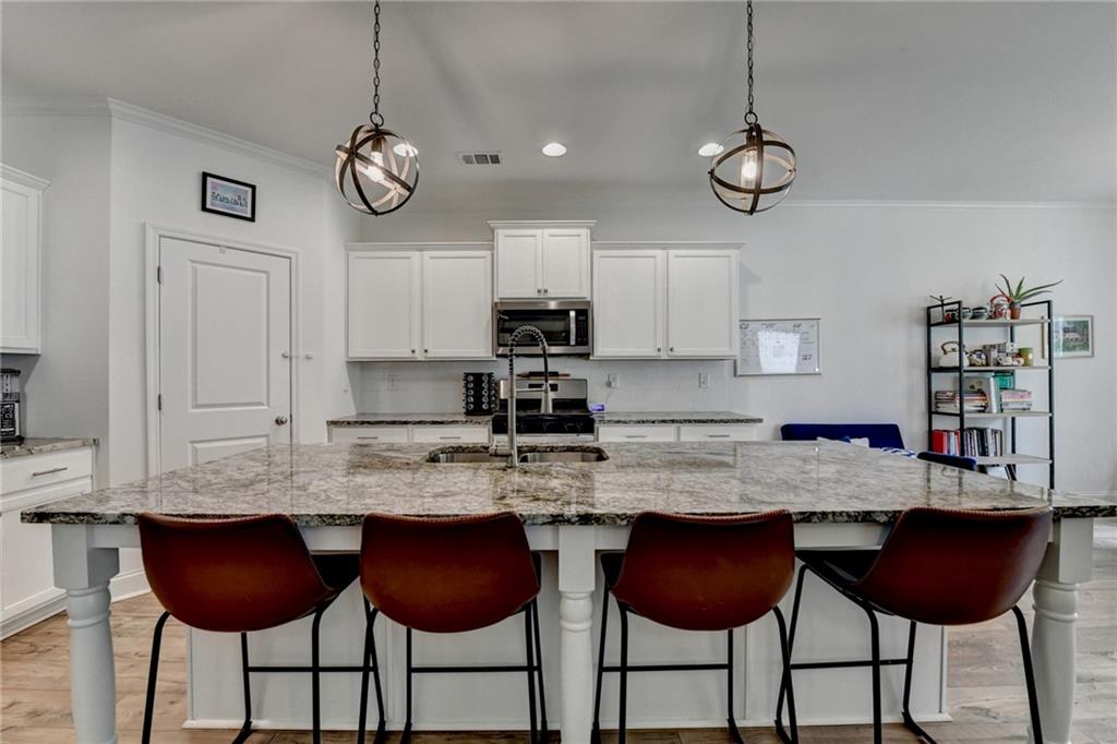 2129 Charmond Drive Monroe, GA 30656 - Photo 6 of 37 a view of kitchen with granite countertop cabinets and chairs