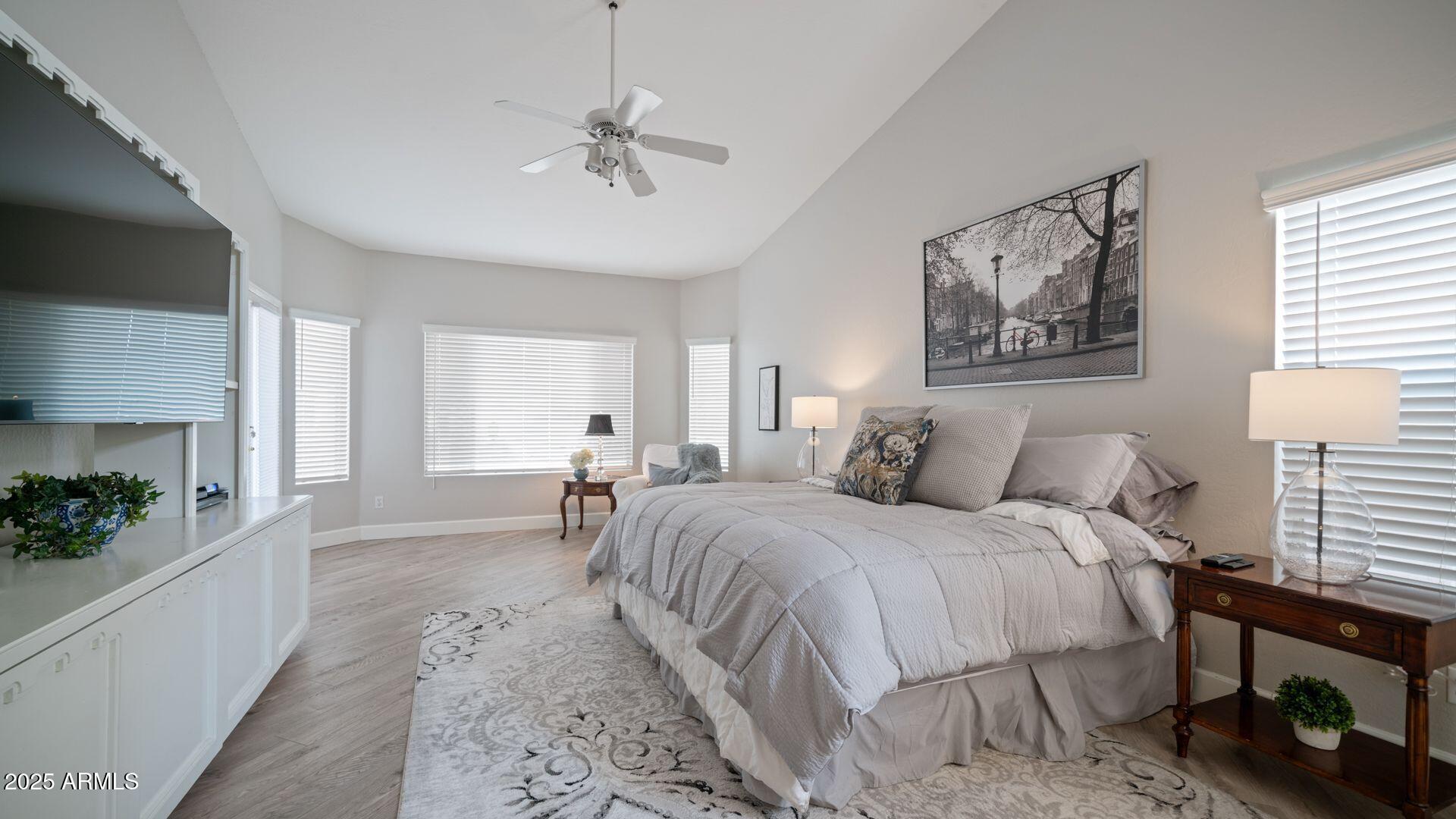 2214 East Beachcomber Drive Gilbert, AZ 85234 - Photo 15 of 45 a spacious bedroom with a bed a couch and potted plant