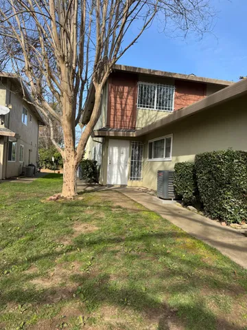 a house that has a tree in front of it