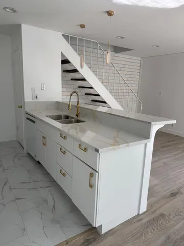 a kitchen with white cabinets and white appliances