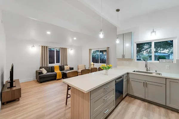 a backyard of a house with table and chairs