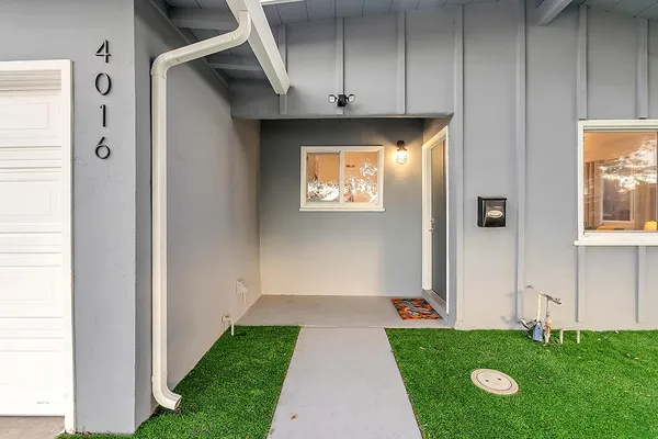 a living room with stainless steel appliances kitchen island granite countertop a refrigerator a stove a sink dishwasher and a dining table with wooden floor