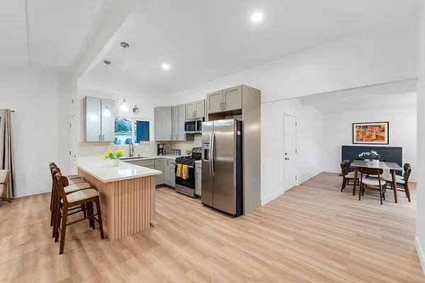 a backyard of a house with table and chairs