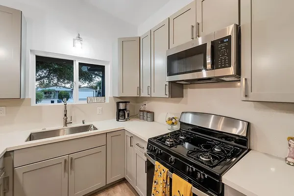 a backyard of a house with table and chairs