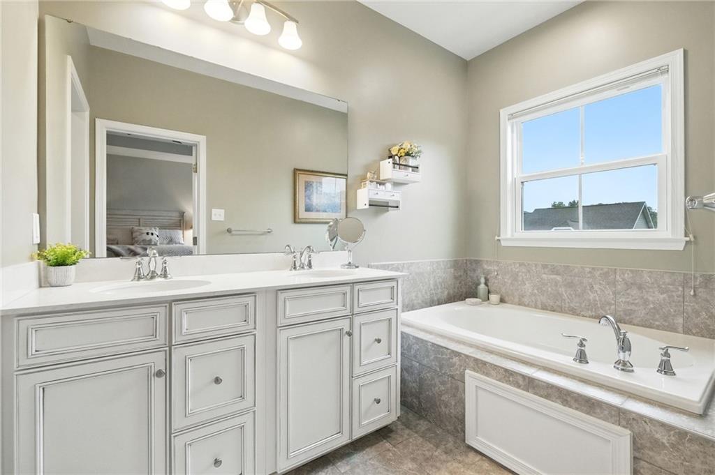 1006 Mohawk Lane Mars, PA 16046 - Photo 26 of 50 a bathroom with a tub a sink and mirror