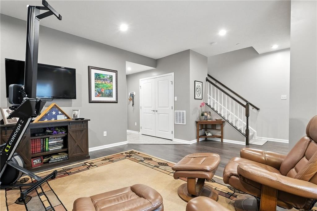 1006 Mohawk Lane Mars, PA 16046 - Photo 37 of 50 a living room with furniture a flat screen tv and gym equipment