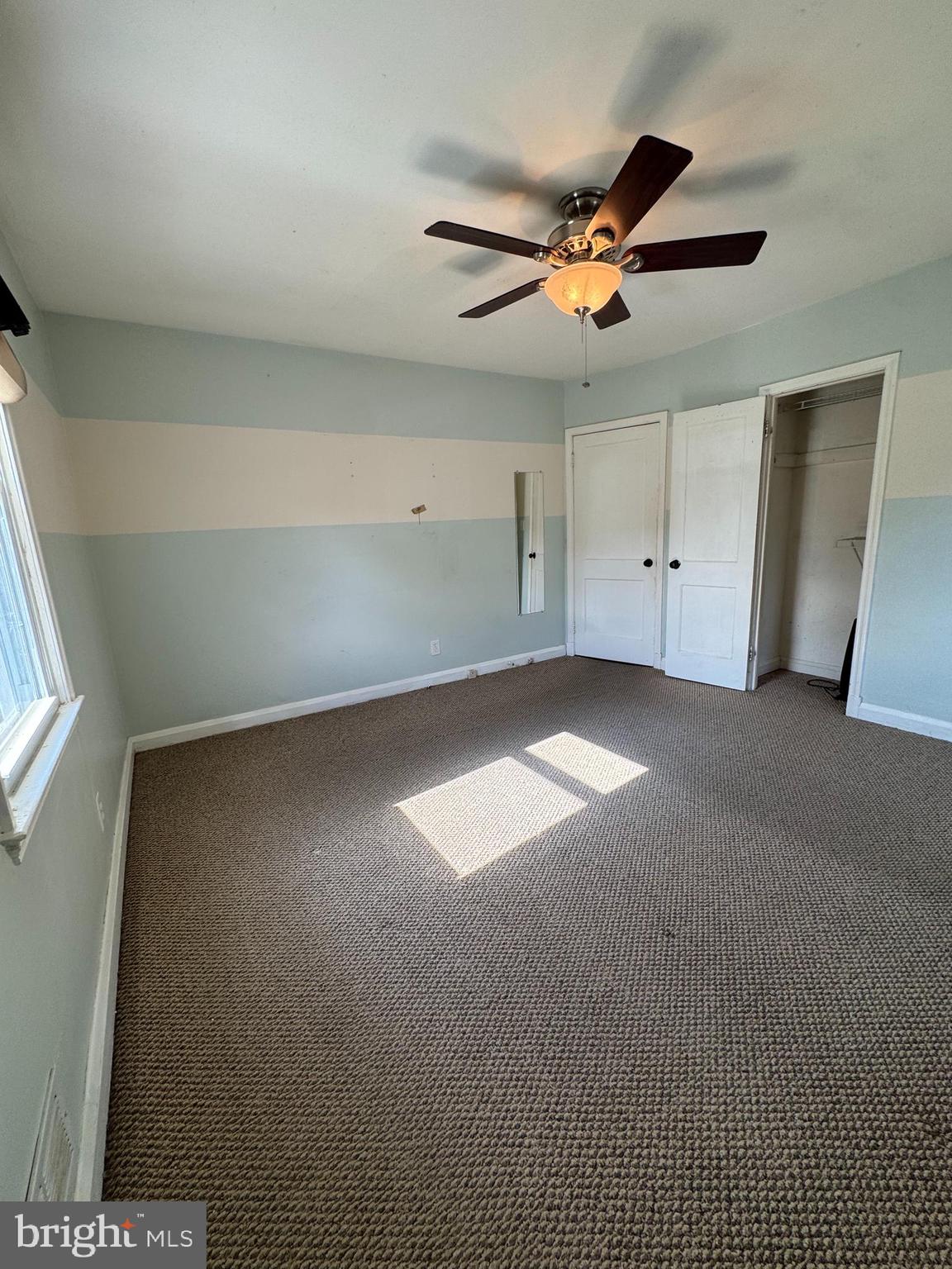 7408 Room Digby Road, Unit 1 Gwynn Oak, MD 21207 - Photo 2 of 9 a view of a livingroom with a ceiling fan and window