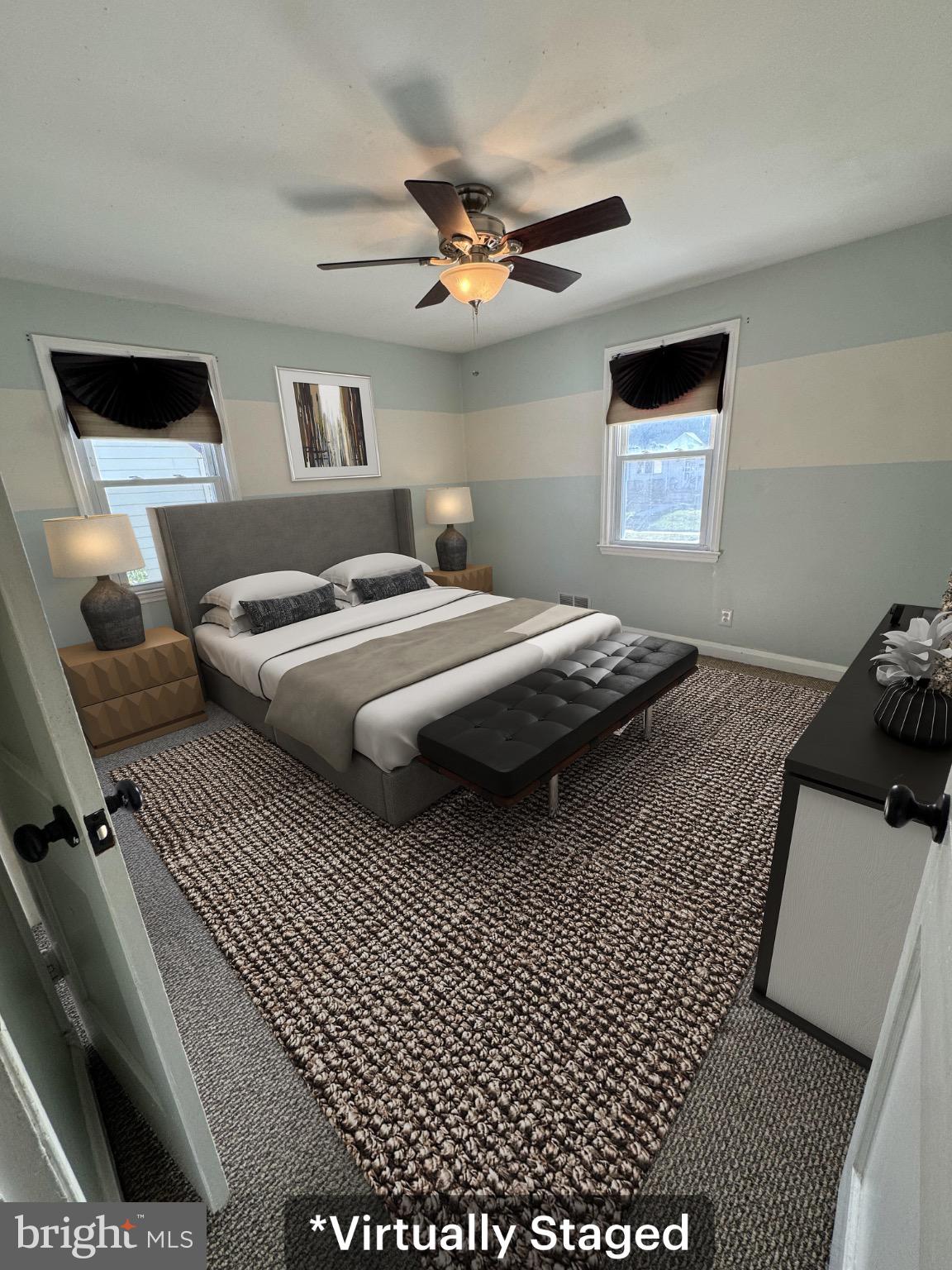 7408 Room Digby Road, Unit 1 Gwynn Oak, MD 21207 - Photo 4 of 9 a bedroom with a bed and a ceiling fan