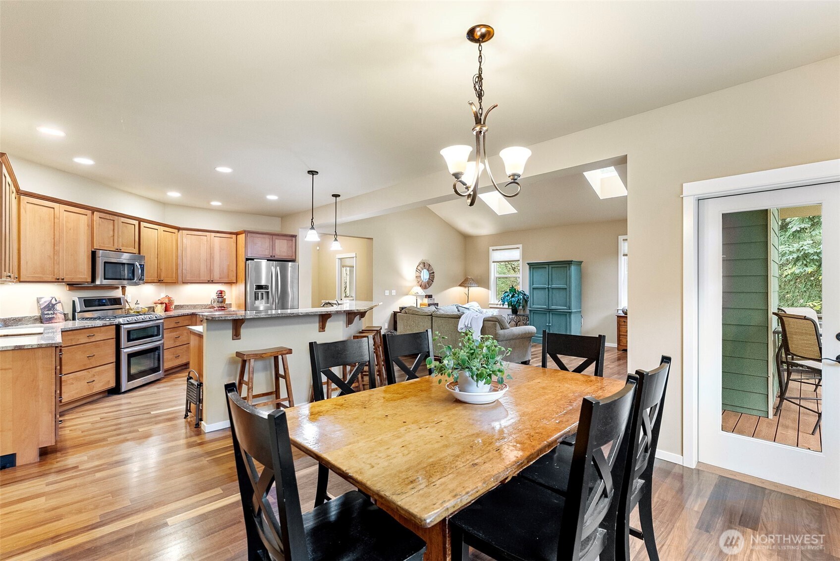 10574 Sidney Road Southwest Port Orchard, WA 98367 - Photo 13 of 37 a view of a dining room and a kitchen with a table chairs