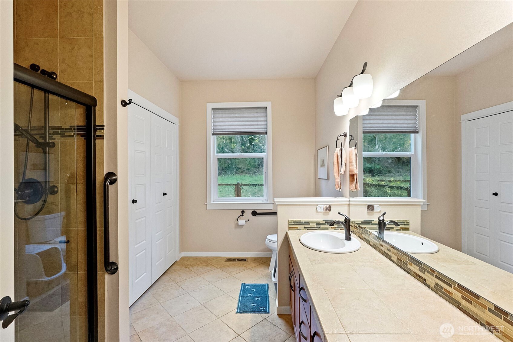 10574 Sidney Road Southwest Port Orchard, WA 98367 - Photo 24 of 37 a bathroom with a tub sink and mirror