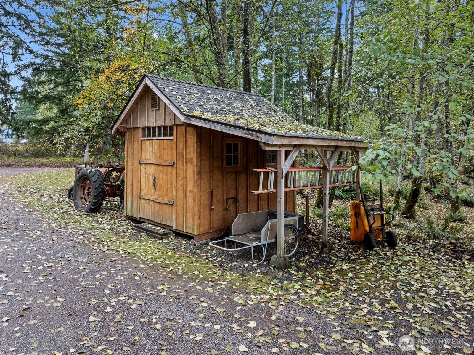 10574 Sidney Road Southwest Port Orchard, WA 98367 - Photo 33 of 37 a view of a small house with yard