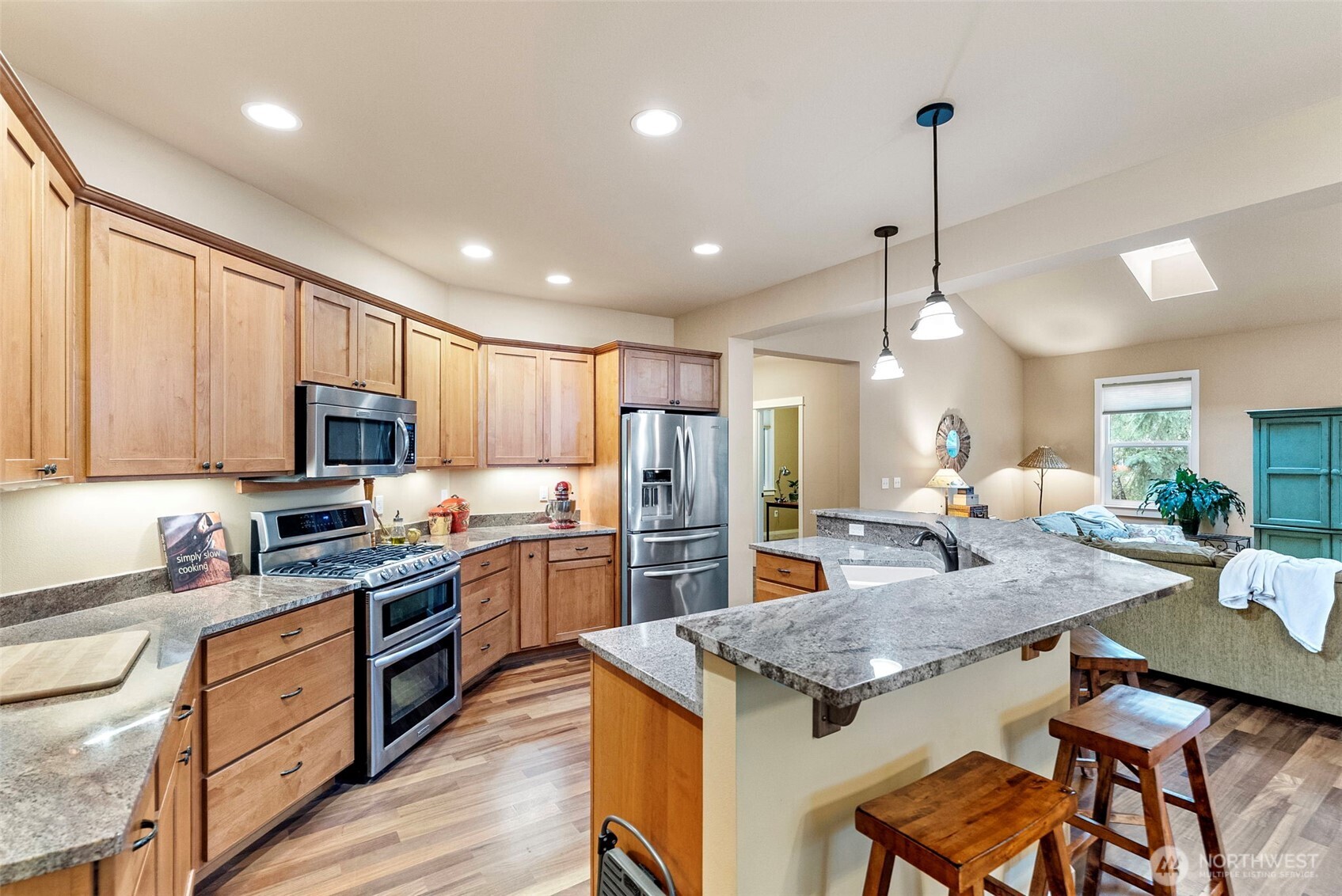10574 Sidney Road Southwest Port Orchard, WA 98367 - Photo 9 of 37 a open kitchen with stainless steel appliances granite countertop a stove refrigerator and cabinets