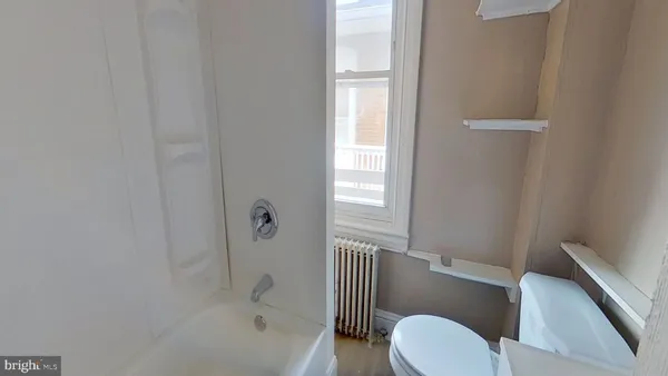 a bathroom with a toilet and a bathtub
