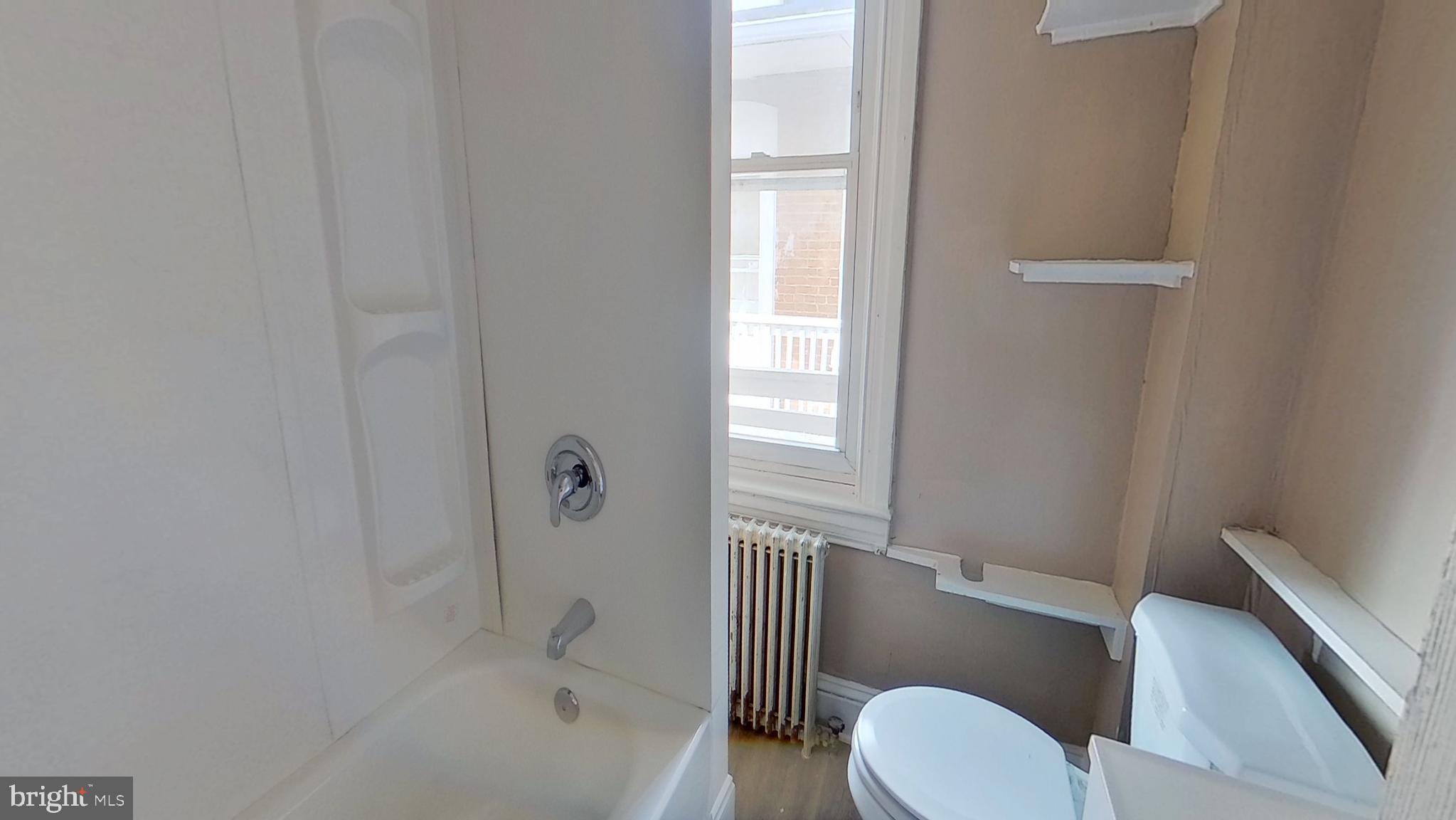 702 West Philadelphia Street, Unit 2 York, PA 17401 - Photo 7 of 10 a bathroom with a toilet and a bathtub