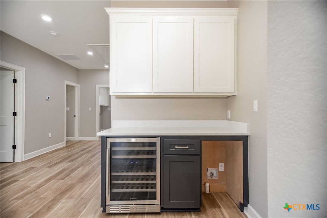74 Whooping Crane Street Port O'Connor, TX 77982 - Photo 13 of 43 a kitchen with granite countertop a stove and a microwave