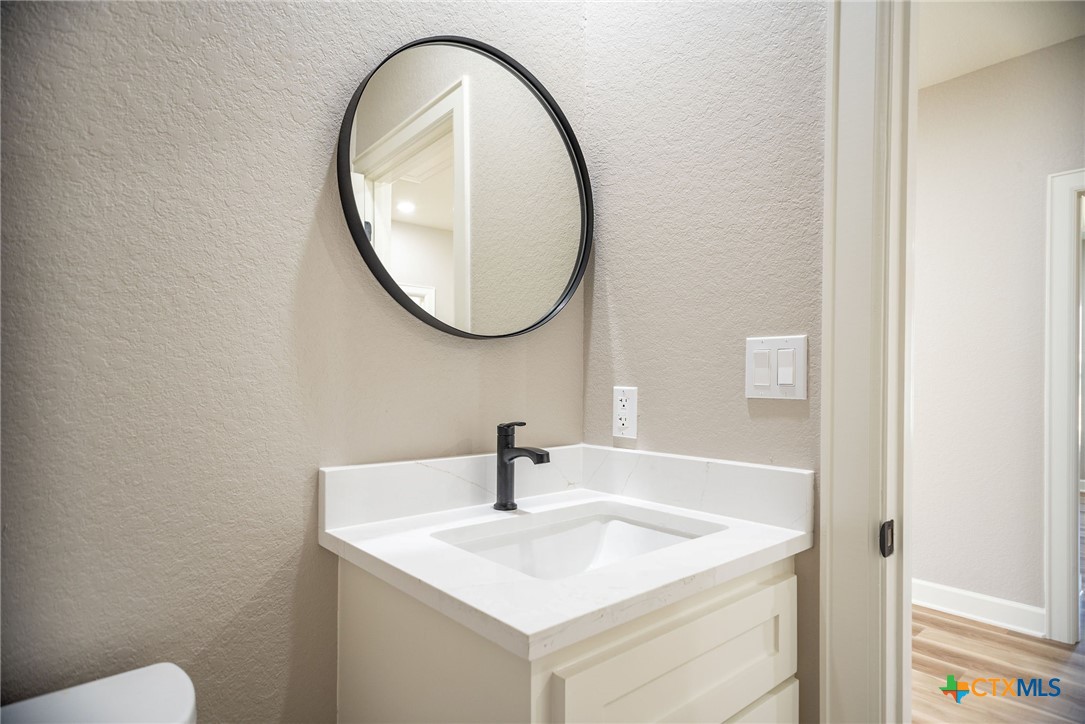 74 Whooping Crane Street Port O'Connor, TX 77982 - Photo 16 of 43 a bathroom with a sink and a mirror