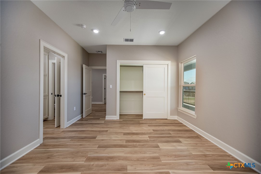 74 Whooping Crane Street Port O'Connor, TX 77982 - Photo 17 of 43 a view of an empty room with wooden floor and closet
