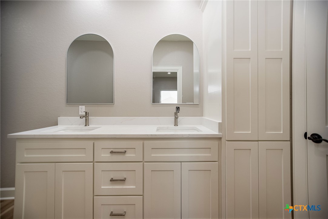 74 Whooping Crane Street Port O'Connor, TX 77982 - Photo 20 of 43 a bathroom with a double vanity sink and a