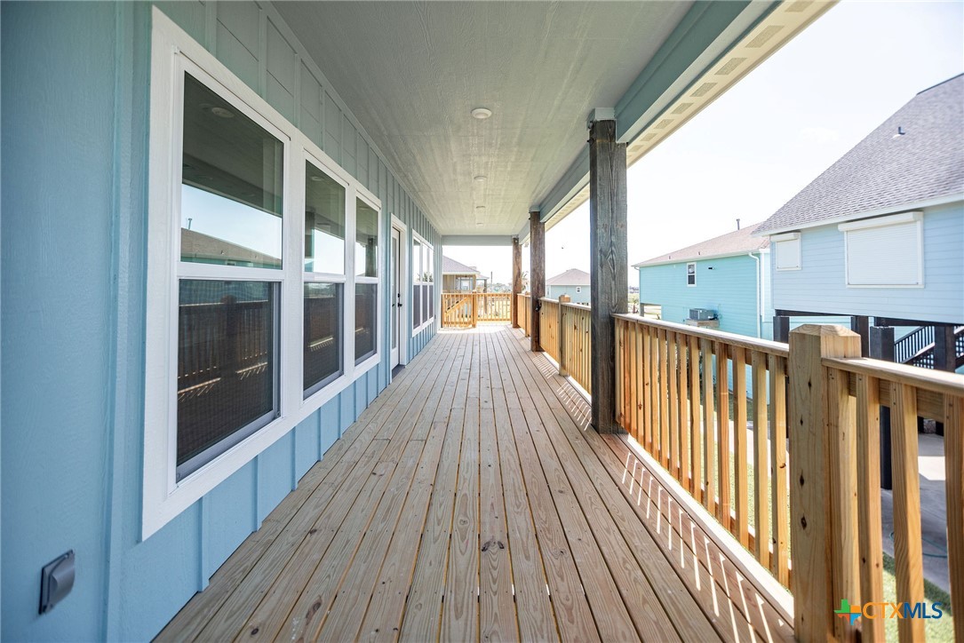 74 Whooping Crane Street Port O'Connor, TX 77982 - Photo 2 of 43 a view of a balcony with wooden floor