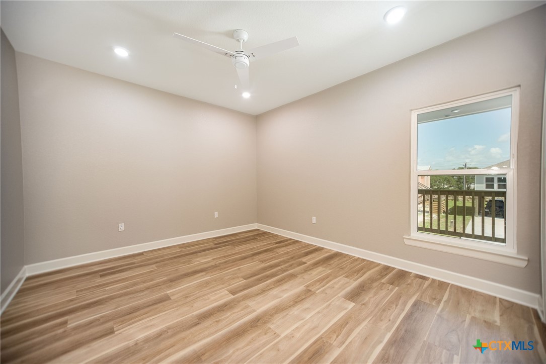 74 Whooping Crane Street Port O'Connor, TX 77982 - Photo 23 of 43 wooden floor in an empty room with a window