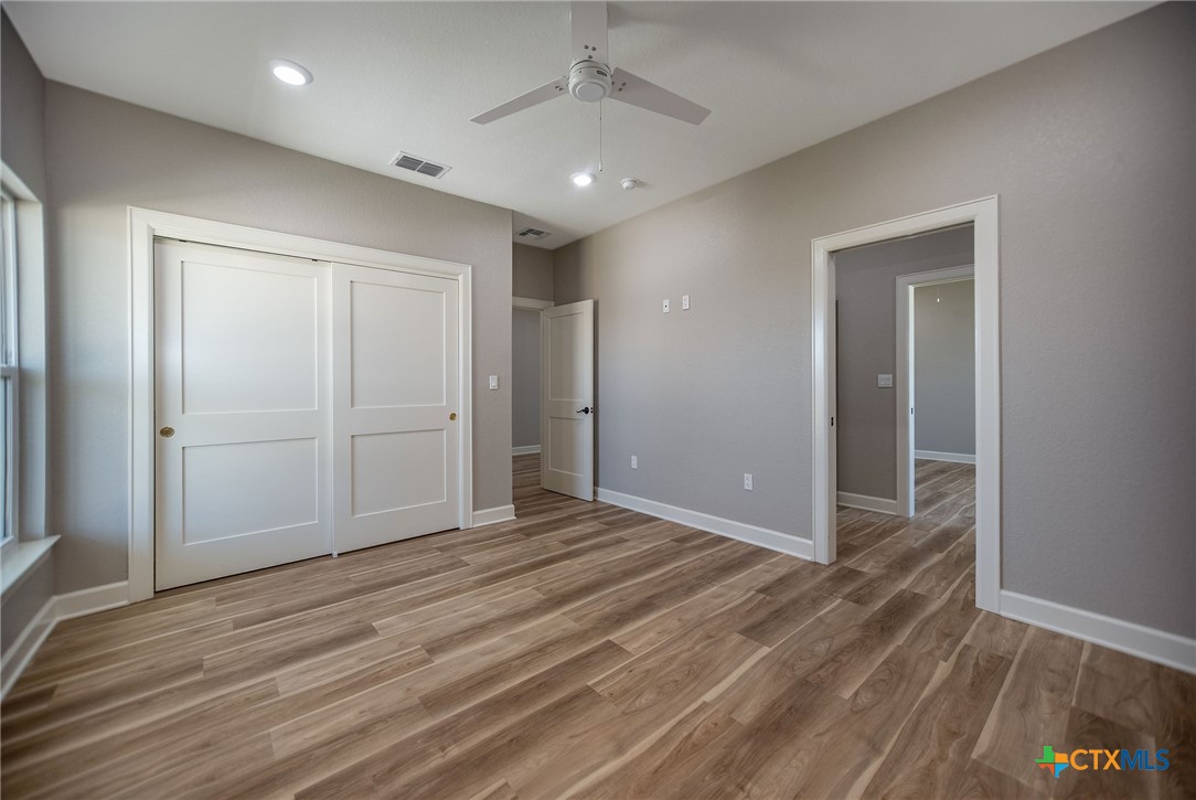 74 Whooping Crane Street Port O'Connor, TX 77982 - Photo 24 of 43 a view of an empty room with wooden floor
