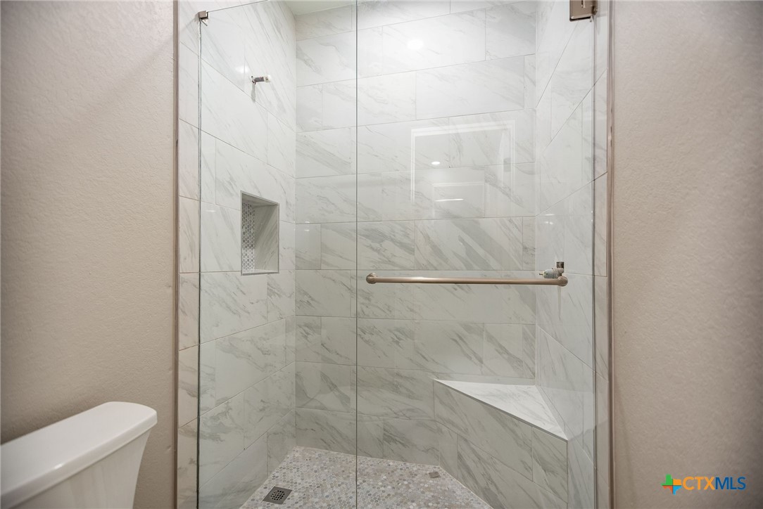 74 Whooping Crane Street Port O'Connor, TX 77982 - Photo 26 of 43 a bathroom with a shower and toilet