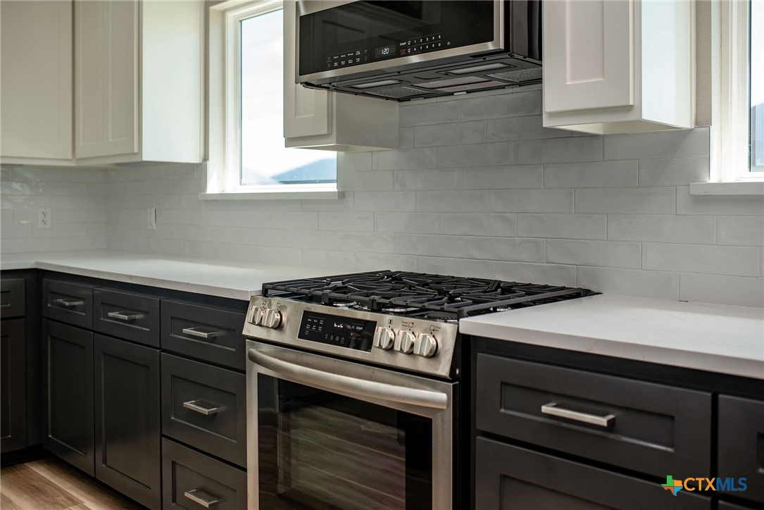 74 Whooping Crane Street Port O'Connor, TX 77982 - Photo 29 of 43 a stove top oven sitting inside of a kitchen