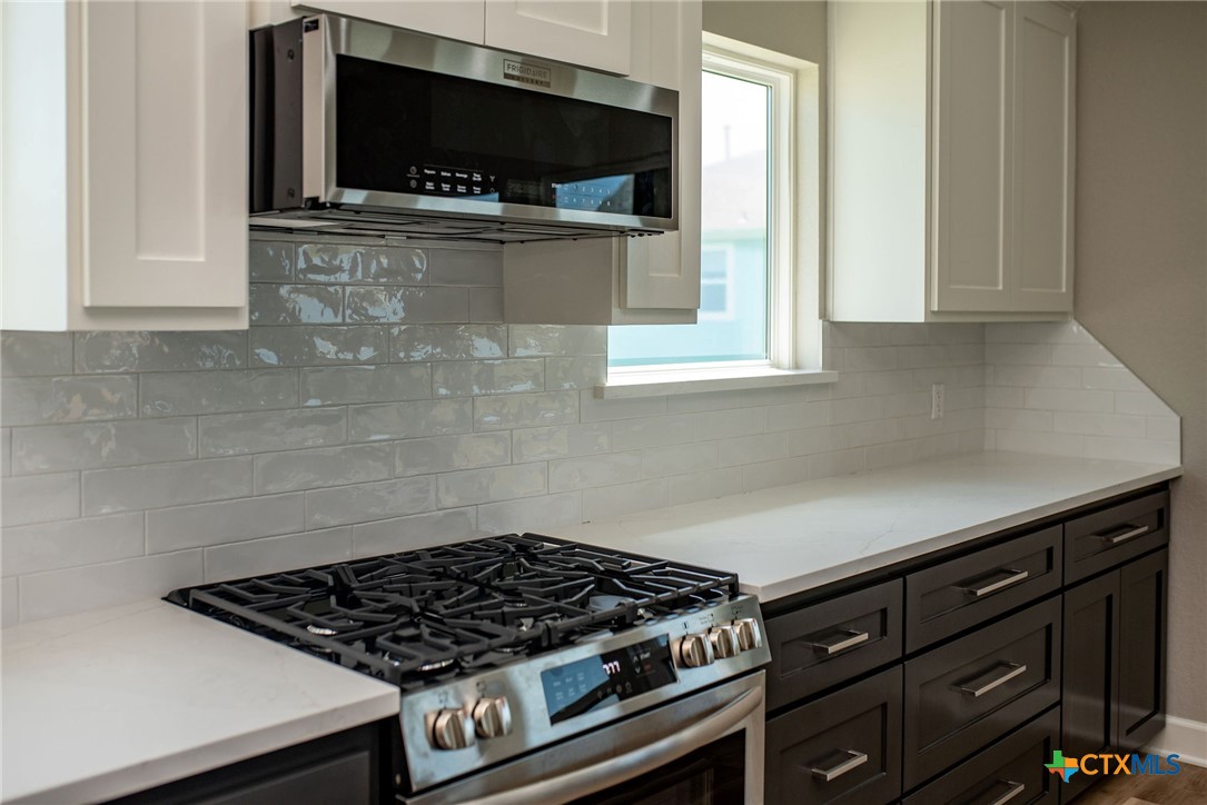 74 Whooping Crane Street Port O'Connor, TX 77982 - Photo 32 of 43 a kitchen with a stove and a microwave
