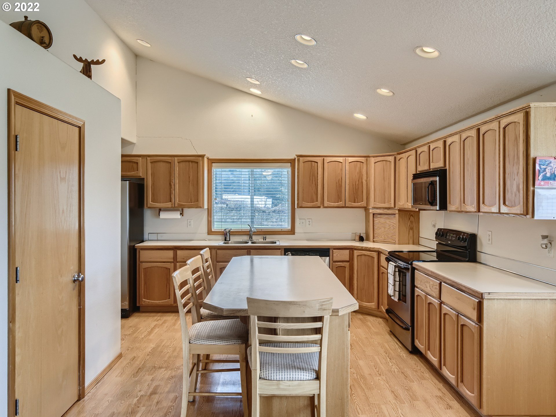 1505 Northeast 194th Street Ridgefield, WA 98642 - Photo 11 of 28 a kitchen with a stove a refrigerator and a sink