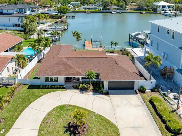an aerial view of a house with swimming pool and outdoor seating