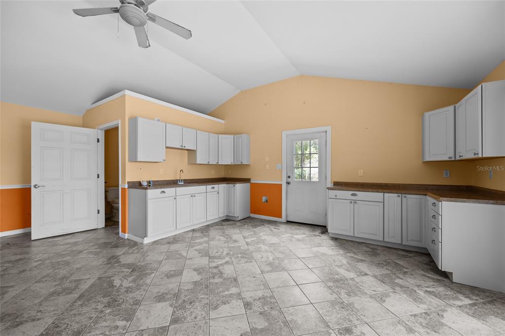 240 Swan Lake Road Melrose, FL 32666 - Photo 19 of 44 a large kitchen with cabinets and stainless steel appliances