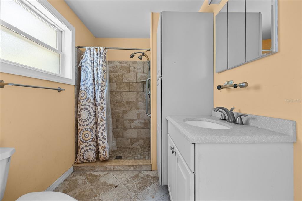 240 Swan Lake Road Melrose, FL 32666 - Photo 22 of 44 a bathroom with a granite countertop sink a toilet and shower