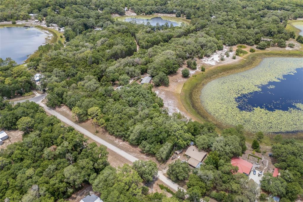 240 Swan Lake Road Melrose, FL 32666 - Photo 37 of 44 an aerial view of a house with a yard and lake view