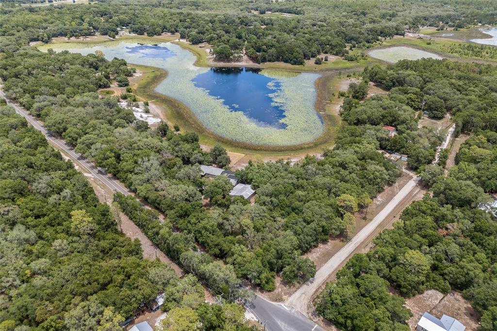 240 Swan Lake Road Melrose, FL 32666 - Photo 39 of 44 an aerial view of a house with a yard and lake view