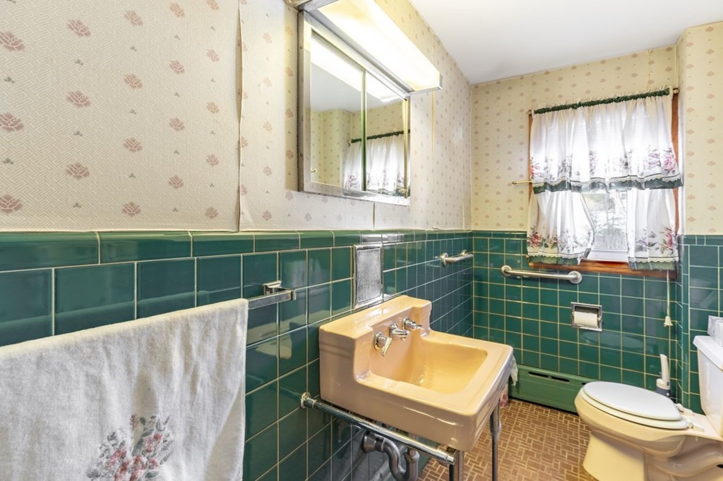 524 South Border Road Winchester, MA 01890 - Photo 16 of 24 a bathroom with a sink toilet and mirror