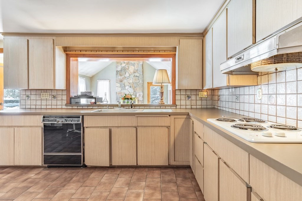 524 South Border Road Winchester, MA 01890 - Photo 10 of 24 a kitchen with stainless steel appliances granite countertop a sink stove and cabinets