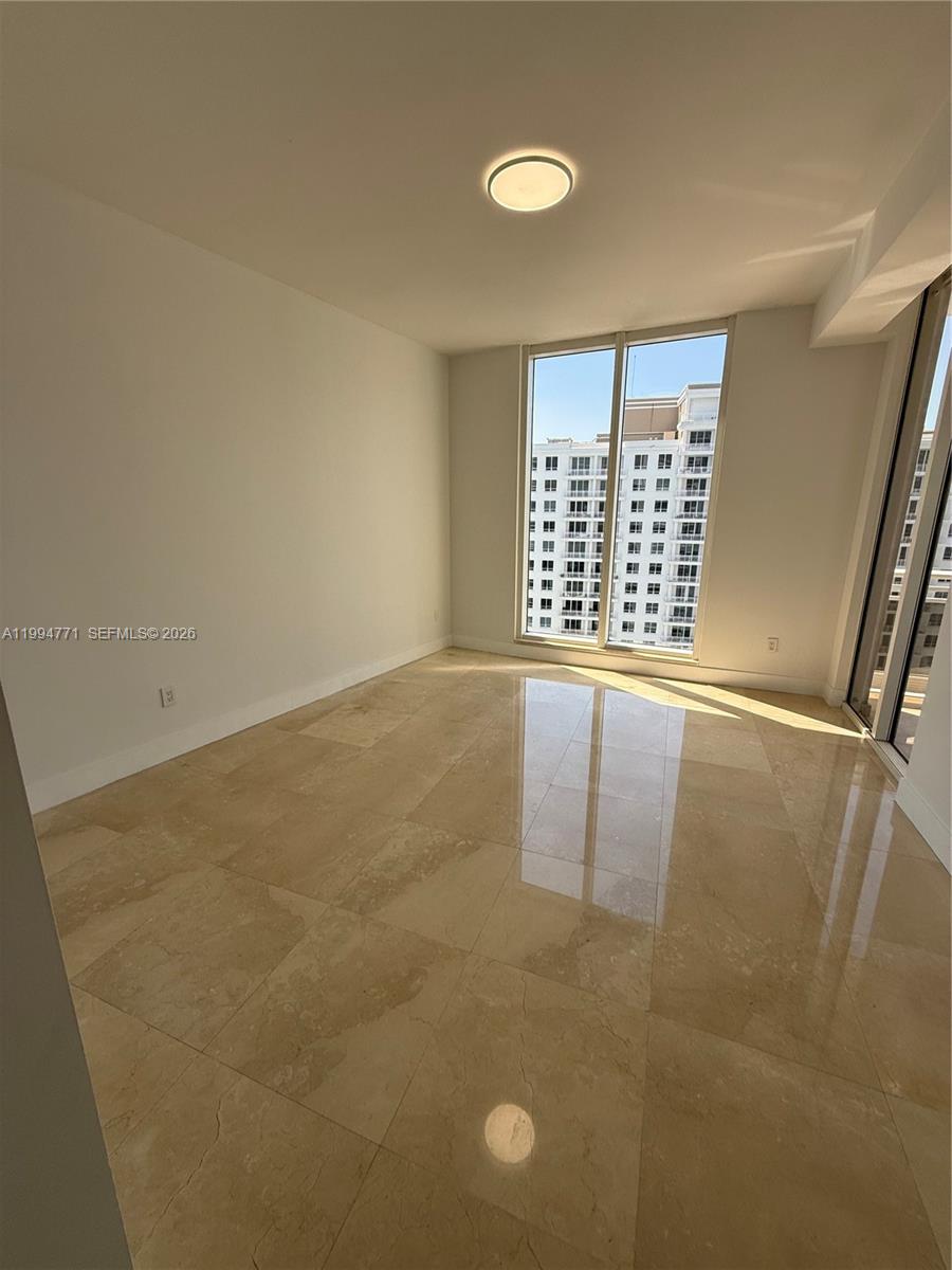 901 Brickell Key Boulevard, Unit 3102 Miami, FL 33131 - Photo 2 of 56 a view of an empty room with a window