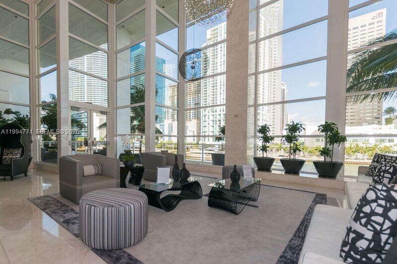 901 Brickell Key Boulevard, Unit 3102 Miami, FL 33131 - Photo 35 of 56 a living room with furniture and a large window