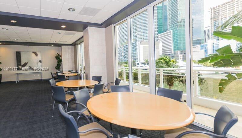 901 Brickell Key Boulevard, Unit 3102 Miami, FL 33131 - Photo 49 of 56 a view of a dining room with furniture window and wooden floor