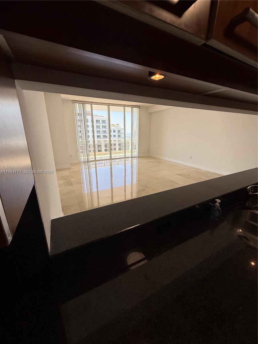 901 Brickell Key Boulevard, Unit 3102 Miami, FL 33131 - Photo 52 of 56 a view of an empty room with wooden floor and windows
