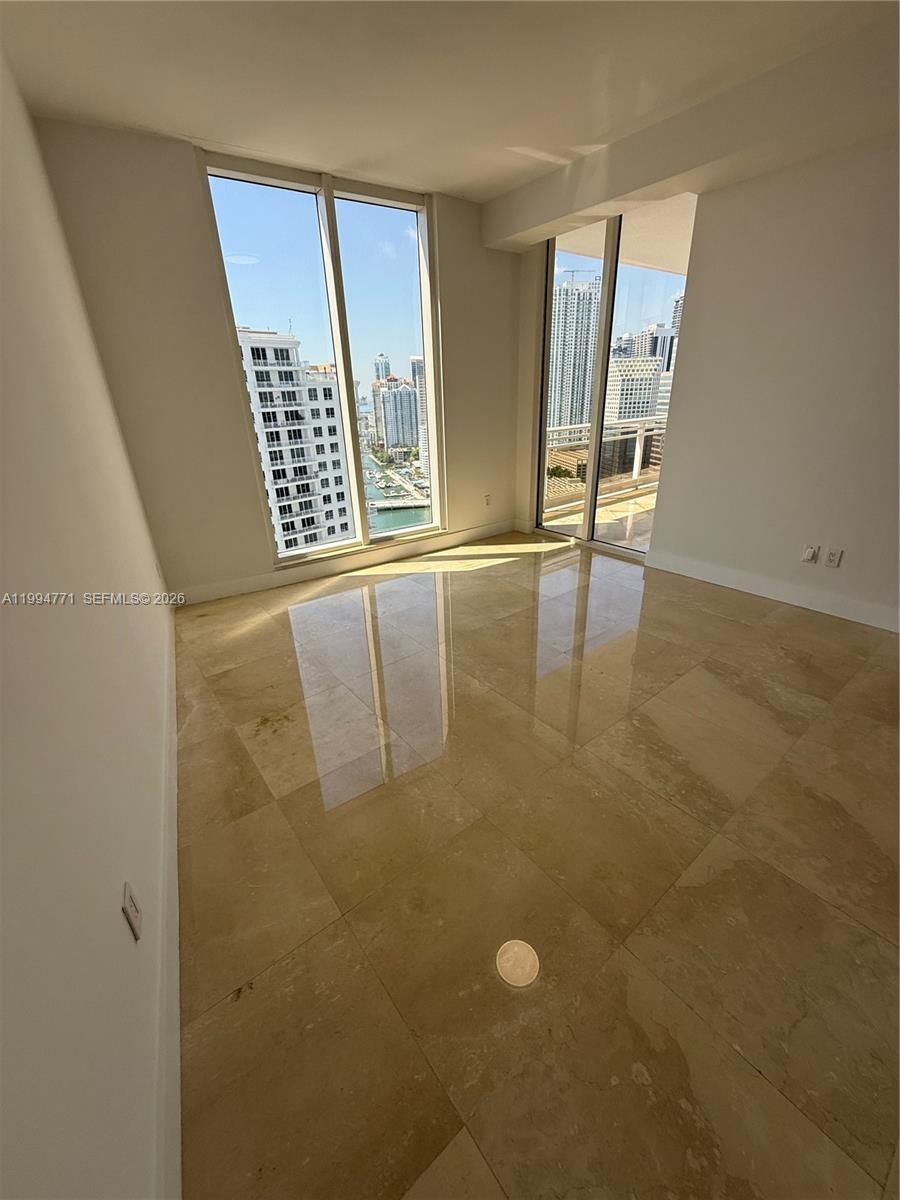 901 Brickell Key Boulevard, Unit 3102 Miami, FL 33131 - Photo 8 of 56 a view of an empty room with windows