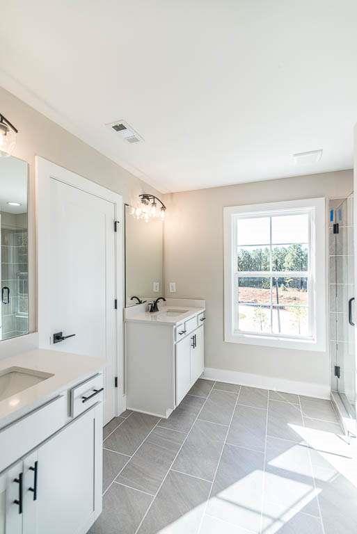 2462 Waldrop Ridge Court Decatur, GA 30034 - Photo 18 of 20 a bathroom with a granite countertop sink a large mirror and a bathtub