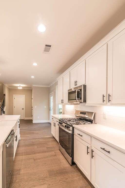 2462 Waldrop Ridge Court Decatur, GA 30034 - Photo 6 of 20 a kitchen with stainless steel appliances granite countertop a stove and a sink