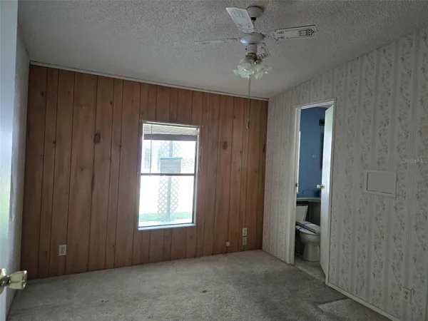 an empty room with windows and closet