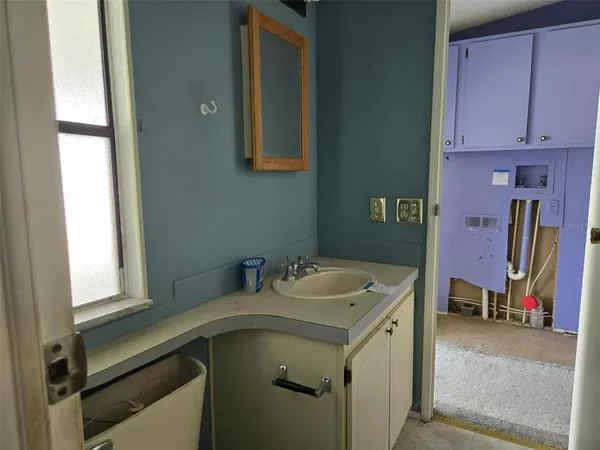 a utility room with a sink dryer and washer