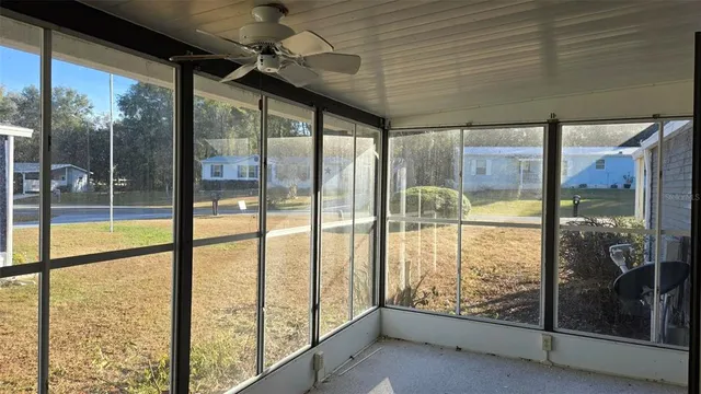 a view of an empty room with windows