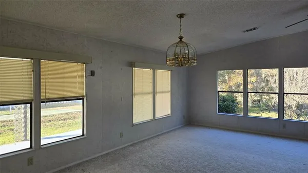 a view of an empty room with windows