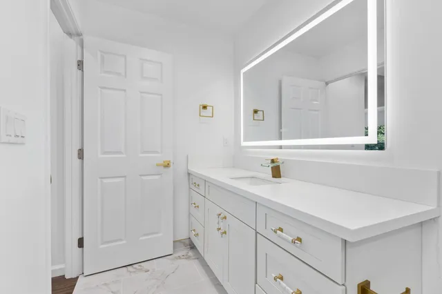 a kitchen with a sink and a mirror