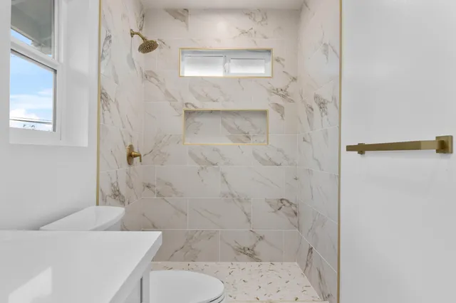 a bathroom with a sink toilet and shower